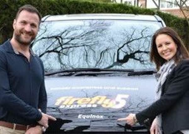 Paul and Sarah Mullen with Firefly vehicle Equinox purchased with funds from the ball