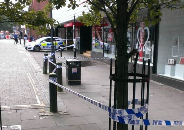 Police sealed off Printing Office Street, where there were bloodstains in a doorway