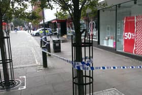 Police sealed off Printing Office Street, where there were bloodstains in a doorway