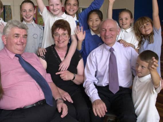David Loy (left) pictured with pupils and fellow staff ahead of his retirement.