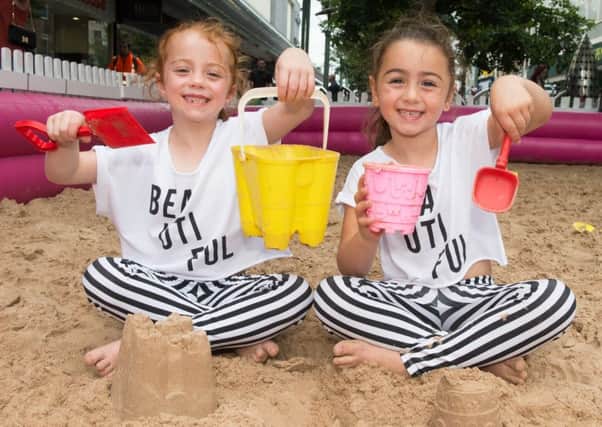 Donny By The Sea in the town centre
Darcie and Sienna Beetham from Askern make sandcastles in the sand pit