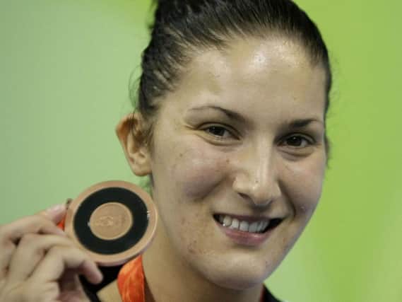 Sarah Stevenson proudly shows off her bronze medal from the 2008 Olympics.
