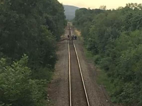 CCTV image of the gang placing wooden planks across railway tracks