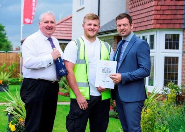 L to r:- Gary Woodhouse, apprentice coordinator, Harry Regan, apprentice of the year and Warren Thompson, managing director of Redrow Homes Yorkshire.