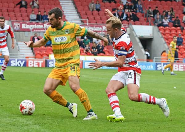 Doncaster Rovers captain James Coppinger challenges a Yeovil opponent. Picture: Marie Caley