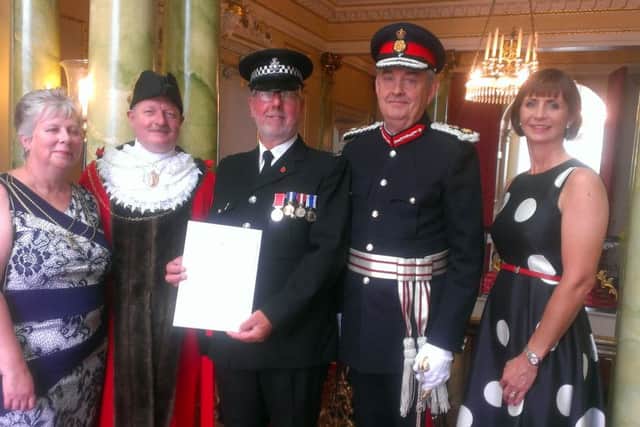 Paul Brown receiving his British Empire Medal
