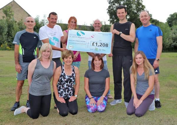 Chris Smith, hospice community fundraiser, back row, second from the left, with Mick Hammond, back row fourth from the left, and with clients of Tall Trees Yoga and Pilates Studio.