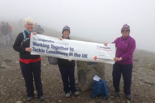 Funeralcare fundraisers on top of Snowdon during their fundraising trek