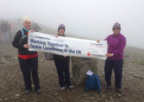 Funeralcare fundraisers on top of Snowdon during their fundraising trek