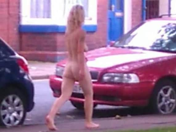 The naked woman goes for a stroll along Chequer Road.