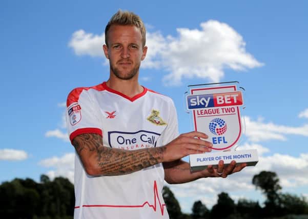 James Coppinger with his Sky Bet League Two Player of the Month award for August.