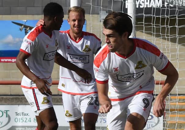 John Marquis celebrates his goal at Morecambe with a Mario Kart impression.
