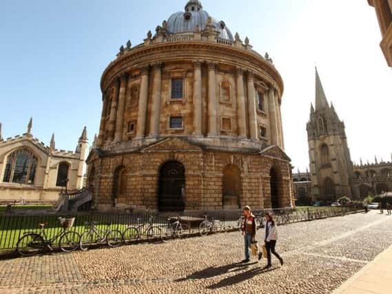 Students walk past the Radcliffe Camera building in Oxford city centre