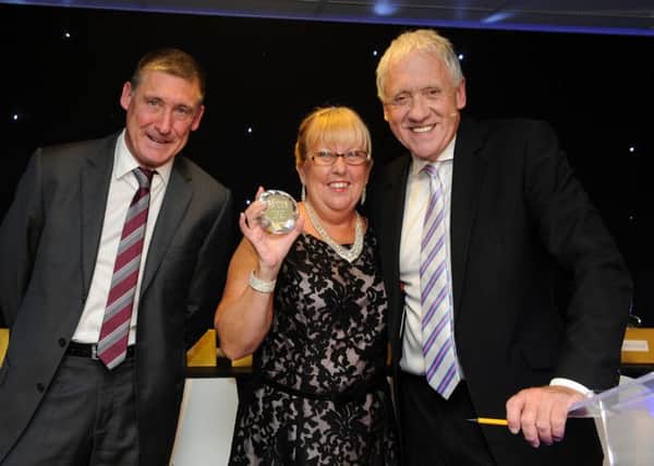 Julie Taylor receives her winners award forthe Unsung Hero Award from Neil Ellis and Harry Gration at the DBH Stars Staff Awards. Picture: Andrew Roe