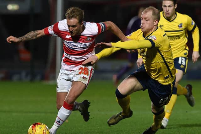Neal Bishop in action for Scunthorpe against Doncaster Rovers' James Coppinger.