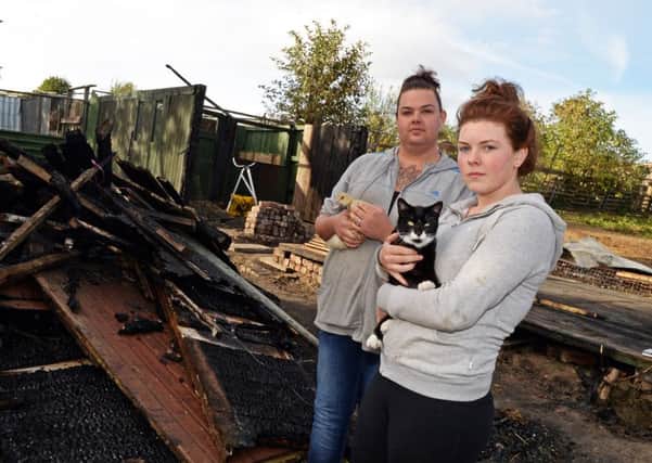 Jessica Lindley and her sister Mary, 15, pictured with two of the animals saved from the fire at their allotment. Picture: Marie Caley NSST Allotment Fire MC 4
