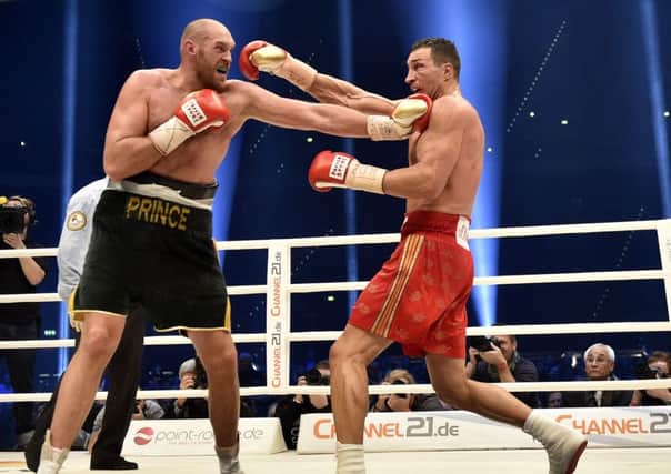 Ukraine's Wladimir Klitschko, right, and Britain's Tyson Fury exchange blows
