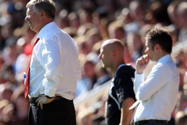 Sir Alex Ferguson and Darren Ferguson in opposing dugouts during a pre-season friendly between Manchester United and Peterborough United