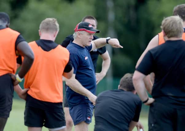 Clive Griffiths (centre) directs training.