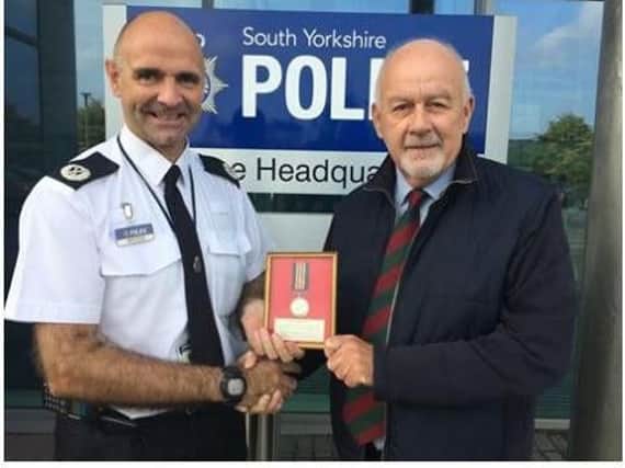 Museum trustee MelSiddons collects Franciss medal from Temporary Assistant Chief Constable Jason Harwin at Force HQ.