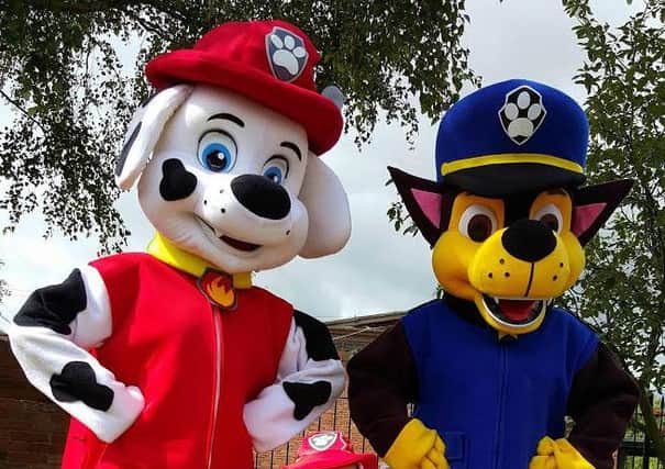 Charachters of Paw Patrol with a young fan ahead of the Christmas lights switch-on.