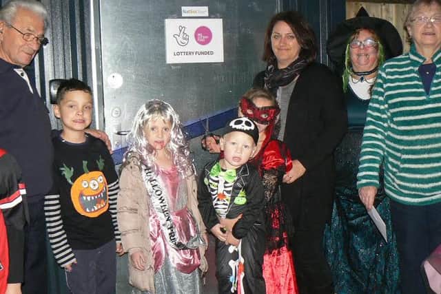 Allotment holders and their young relatives celebrate the cash boost.