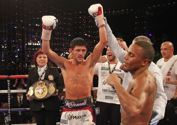 Jamie McDonnell has his hand raised at the end of his war with Liborio Solis in Monte Carlo