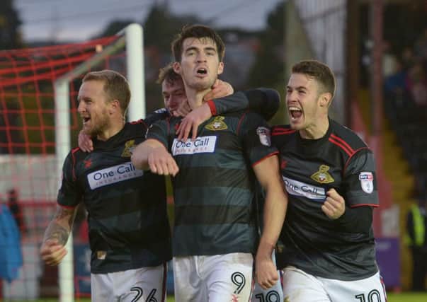 Nine-goal striker John Marquis celebrates scoring in the come-from-behind win at Exeter.