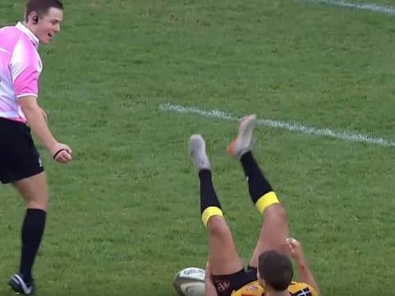 Laurence May is sent sprawling by referee Jack Makepeace. (Photo: YouTube).