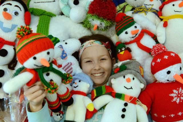 Grandma Carol Connelly with 12 year old Laura Powell and their knitted snowmen that they raffled off to raise over Â£2000