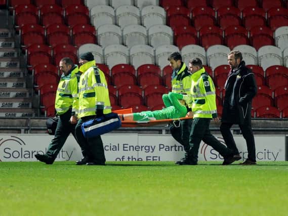 Marko Marosi is stretchered off during the win over Portsmouth