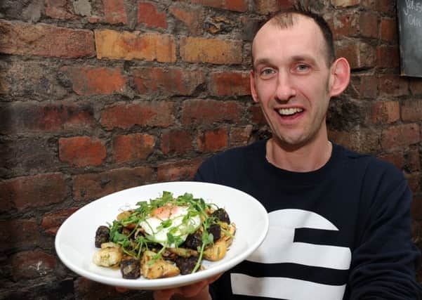 Jonty Cork holds up a wild mushroom, black pudding and new potato hash with a fried egg dish at Made By Jonty, Sharrow Vale Road.