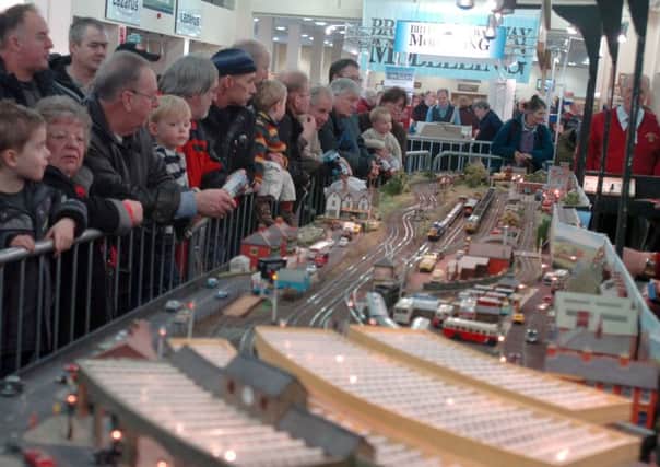 Railway Exhibition . Pictured at the Model railway Show at the Doncaster Race course are...Visitors admire   the Wingfield Junction Railway Groups layout.