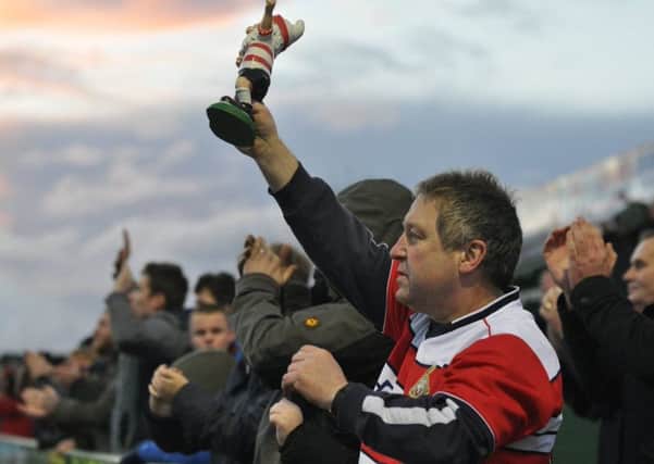Paul Mayfield holds aloft his gnome at Yeovil. Photo: Phil Ryan