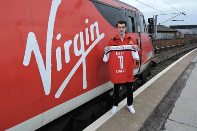 Goal-den opportunity: Doncaster Rovers top scorer John Marquis puts his shirt on sponsors Virgin Trains