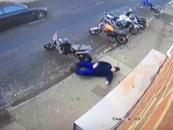 The man laid flat out on the pavement outside Doncaster Motorcycles. (Photo: YouTube).