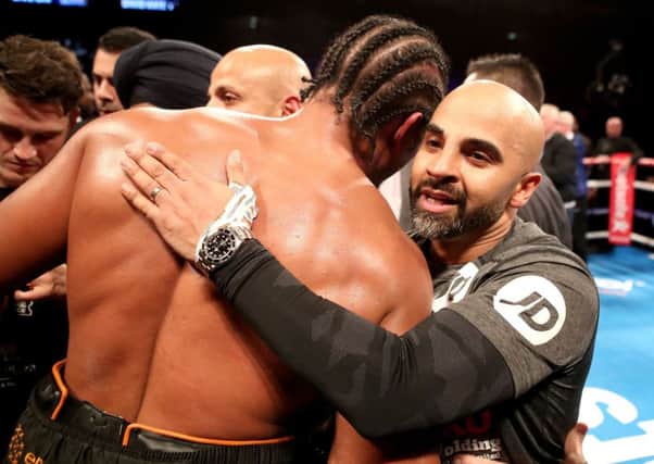 David Haye is embraced by the trainer of Tony Bellew, Dave Coldwell (right) after losing the heavyweight contest at The O2. Pix: Nick Potts/PA Wire