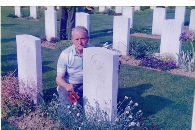 Lance Corporal Fred Adamson visits his mate Ronnie McGrath's grave in France