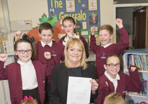 Principal Kay Godfrey and pupils at Gooseacre School celebrate their letter from School Standards Minister Nick Gibb