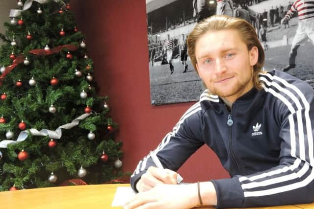 Alfie May signs his deal with Doncaster Rovers