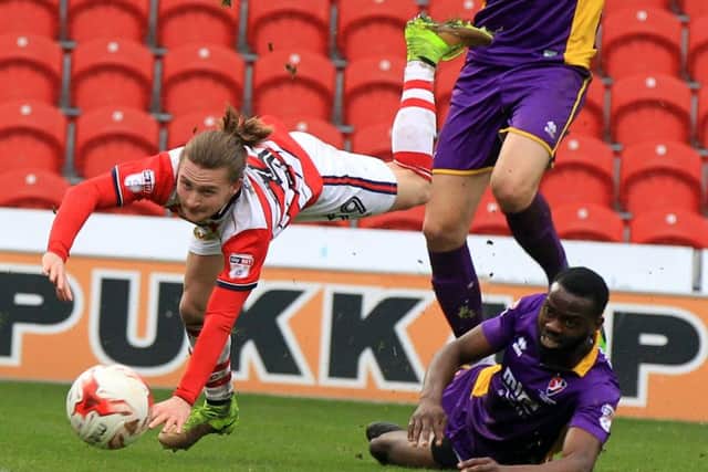 Alfie May takes a tumble against Cheltenham Town