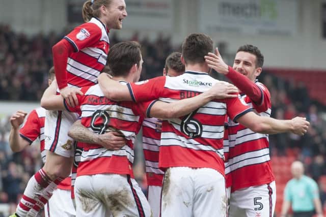 Alfie May celebrates with team mates after Rovers score