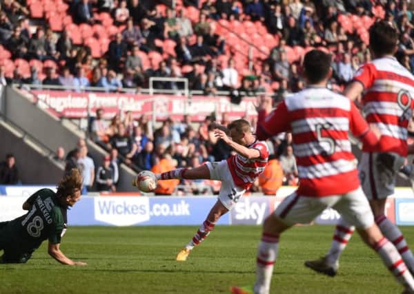 James Coppinger volleys at goal for Doncaster Rovers