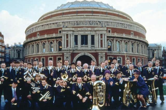 The cast and Grimethorpe Colliery Band outside the Royal Albert Hall in 1996.