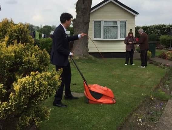 Ed Miliband mowing a voter's lawn in Doncaster. (Photo: Jane Nightingale).