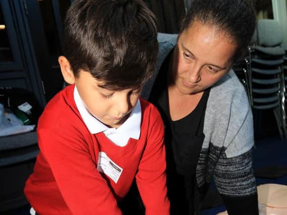 Dan Fagg who suffered a heart attack on a football pitch takes part in Restart a Heart Day at Hayfield School in Auckley. Dan is pictured with mum Hayley Thomson.