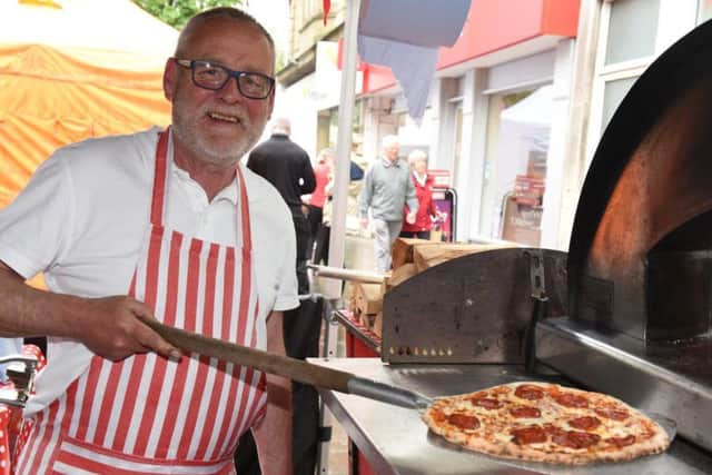 Geoff Holmes gets a pizza out of the oven at the Doncaster Food Festival