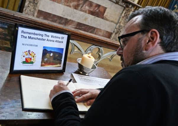 Organist Darren William, pictured signing the book of condolence at the Doncaster Minster. Picture: Marie Caley NDFP Minster Condolence MC 1