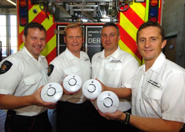 Smoke alarms with firefighters from left Robert West, Darren Higgins, Jason Jenkinson and Daniel Turner.
