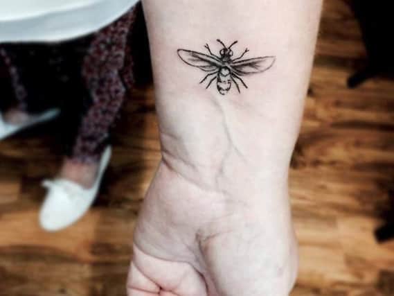 The customer had a bee tattoo inked on her wrist. (Photo: Jono Smith).